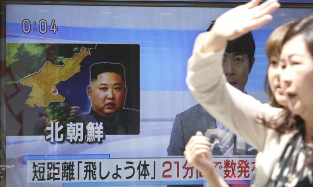 People walk past a screen showing a TV news on unidentified short-range projectiles fired by North Korea, in Tokyo, Saturday, May 4, 2019. North Korea on Saturday fired several unidentified short-range projectiles into the sea off its eastern coast, the South Korean Joint Chiefs of Staff said, a likely sign of Pyongyang's growing frustration at stalled diplomatic talks with Washington meant to provide coveted sanctions relief in return for nuclear disarmament. (Photo by Koji Sasahara/AP Photo)