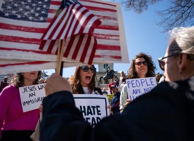 A woman holding American flags confronts counter-protesters as conservative groups hold a rally at the state Capitol to call for protection of the Tennessee border from migrants crossing into the U.S., in Nashville, Tennessee on March 20, 2024. (Photo by Seth Herald/Reuters)