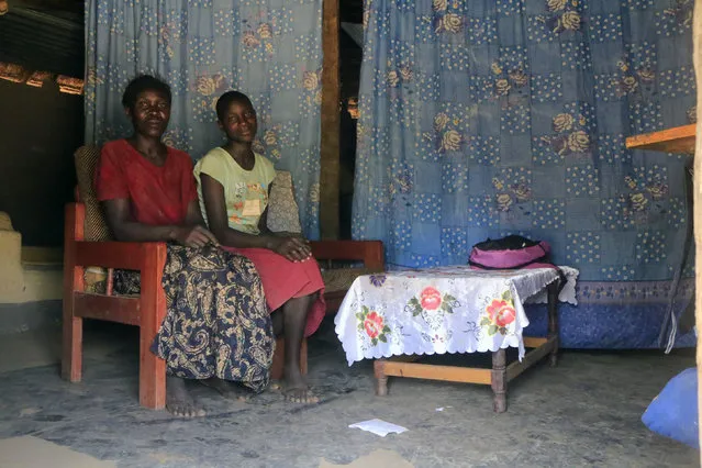 Lucy Oyela, 42, poses for a photograph with her daughter Abber Lillian, 14, at their home in Onang near Gulu town in northern Uganda February 16, 2014. Lucy is a farmer who finished her education at age 18. She said that when she was a child, she wanted to become a teacher when she grew up. Lucy says that she really wants for her daughter to become a nurse. Her daughter Abber Lillian says she doesn't know at what age she will finish education. (Photo by James Akena/Reuters)