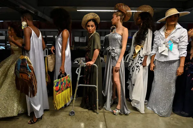 Models wait backstage during the Walkway Inclusion fashion show in Cali, Colombia on May 16, 2019. People with physical and cognitive disabilities, Afro-descendants, members of the LGBTI community, indigenous people, albinos, size women, homeless people and women deprived of their freedom participate in the Walkway Inclusion Fashion Show, which aims to break paradigms that fashion is only for normal people and generate a space where fashion is for everyone. (Photo by Luis Robayo/AFP Photo)
