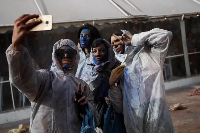 Revellers take a “selfie” as they celebrate “Ash Monday” by participating in a colourful “flour war”, a traditional festivity marking the end of the carnival season and the start of the 40-day Lent period until the Orthodox Easter,in the port town of Galaxidi, Greece, February 27, 2017. (Photo by Alkis Konstantinidis/Reuters)