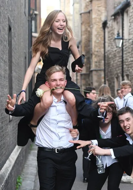 Students from Cambridge University make their way home along Trinity Lane after celebrating the end of the academic year at a May Ball in Trinity College on June 18, 2019. (Photo by Joe Giddens/PA Images via Getty Images)