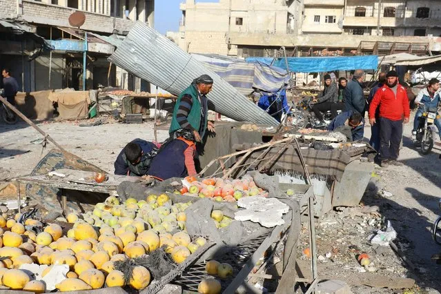 People salvage goods from a market after airstrikes in the rebel-controlled town of Ariha in Idlib province, Syria February 25, 2017. (Photo by Ammar Abdullah/Reuters)