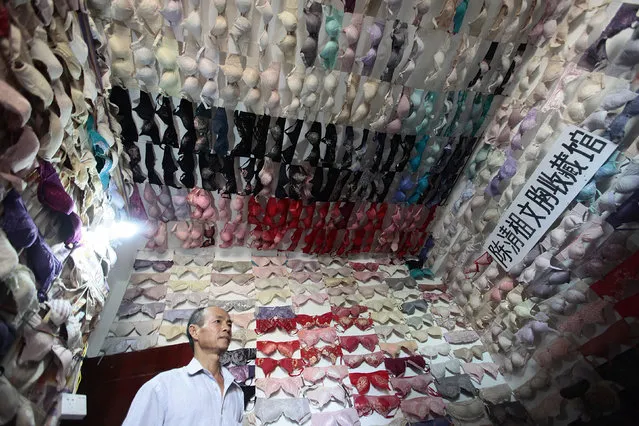 Chen Qingzu stands in a small room with the walls and ceiling covered in bras he collected, in Sanya, Hainan province April 22, 2014. Chen has collected about 5,000 bras over 20 years after touring more than 30 different colleges around the country for public benefit activities aiming to raise awareness of breast cancer, local media reported. (Photo by Reuters/Stringer)