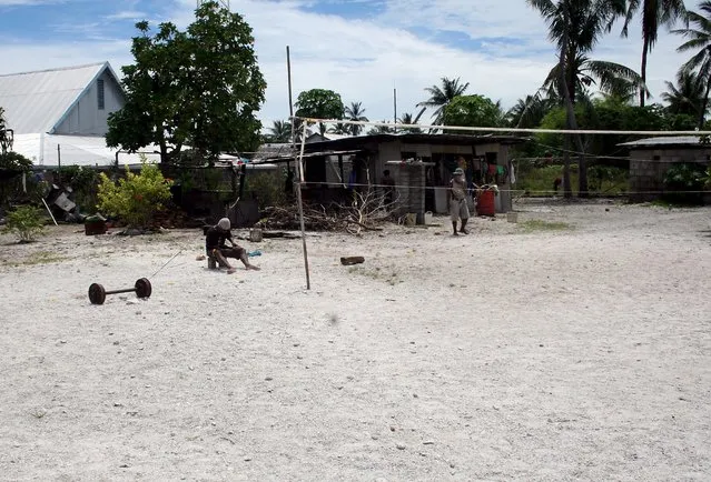 A prisoner makes a fishing net as he sits in the yard of a prison located on Kiritimati Island, part of the Pacific Island nation of Kiribati, April 5, 2016. (Photo by Lincoln Feast/Reuters)