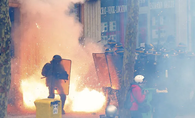 French riot police officers (CRS) face protestors during clashes during a demonstration against the French labour law proposal in Paris, France, as part of a nationwide labor reform protests and strikes, April 28, 2016. (Photo by Charles Platiau/Reuters)