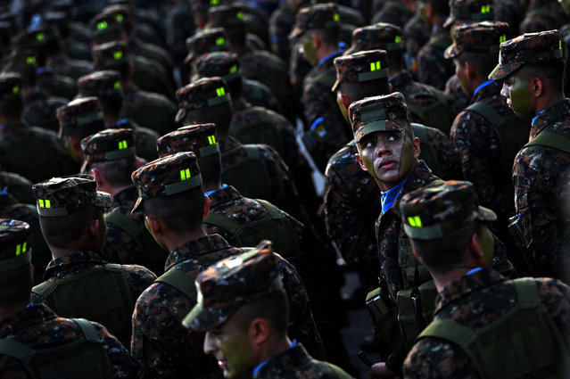 Some of 1,000 soldiers joining the Salvadoran Armed Forces remain at Gerardo Barrios square in the historical center of San Salvador, on July 29, 2019, to be reviewed by Salvadoran President Nayib Bukele. Bukele ordered the incorporation of 1,000 men to the Armed Forces to reinforce his Territorial Control Plan against gangs. (Photo by Marvin Recinos/AFP Photo)