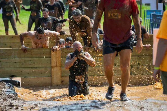 Participants take part in the first Mud Day Israel obstacle course race in Tel Aviv, Israel March 24, 2017. (Photo by Baz Ratner/Reuters)