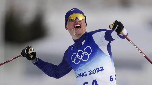 Iivo Niskanen, of Finland, celebrates as he crosses the finish line during the men's 15km classic cross-country skiing competition at the 2022 Winter Olympics, Friday, February 11, 2022, in Zhangjiakou, China. (Photo by Alessandra Tarantino/AP Photo)
