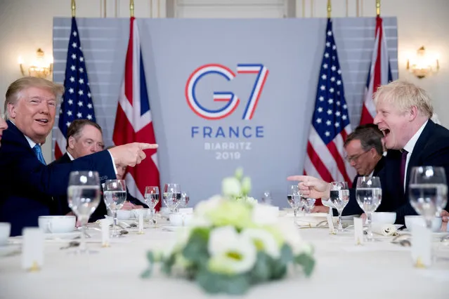 U.S. President Donald Trump, left, and Britain's Prime Minister Boris Johnson attend a working breakfast at the Hotel du Palais on the sidelines of the G-7 summit in Biarritz, France, Sunday, August 25, 2019. (Photo by Andrew Harnik/AP Photo)