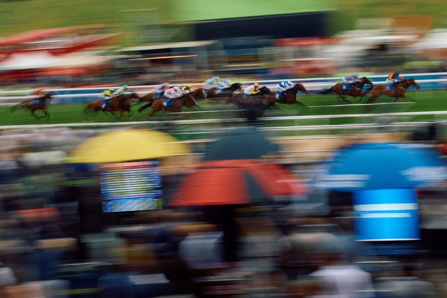 Jockeys ride their horses during a race on the first day of the Epsom Derby Festival horse racing event in Surrey, southern England on May 31, 2024. (Photo by Benjamin Cremel/AFP Photo)
