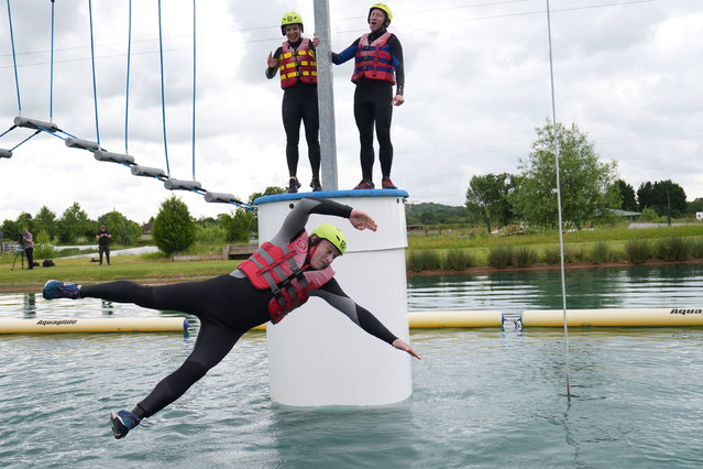 Liberal Democrats leader Sir Ed Davey jumps into the water as he attempts an Aqua Jungle floating assault course during a visit to Spot-On-Wake in Henley-in-Arden, Warwickshire, while on the General Election campaign trail on Wednesday, June 12, 2024. (Photo by Jacob King/PA Images via Getty Images)