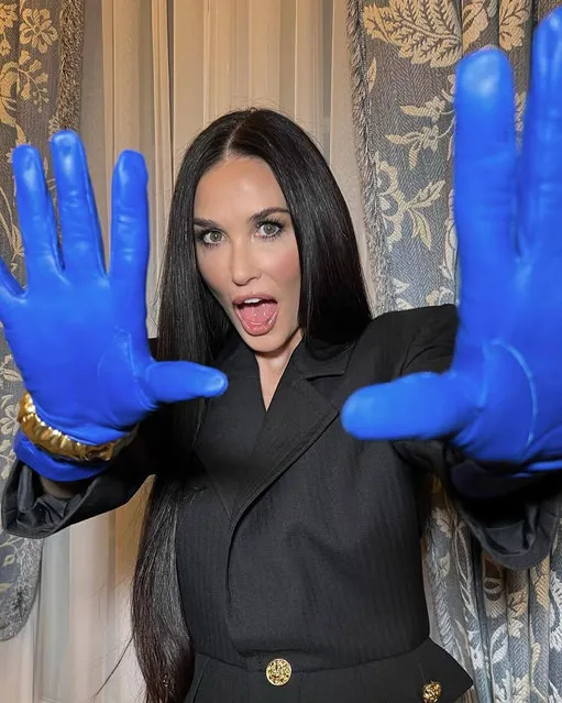 American actress Demi Gene Moore shows off her royal blue gloves in early March 2022. (Photo by demimoore/Instagram)