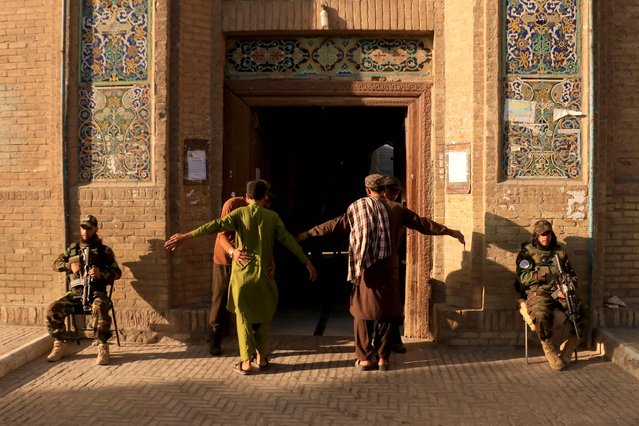 Security personnel frisk devotees entering to offer Eid al-Adha prayers at Jami mosque in Herat on June 17, 2024. (Photo by Mohsen Karimi/AFP Photo)