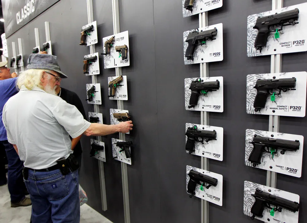 Gun Fans Admire Weapons at NRA Meeting