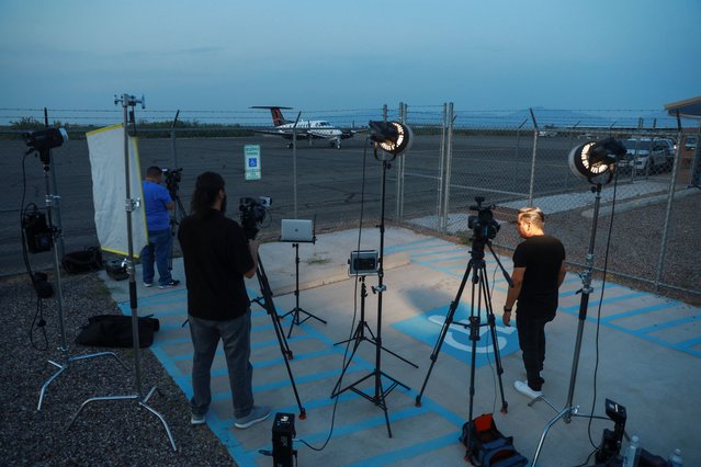 Media personnel stand at Dona Ana County private airport where a plane believed to have carried Mexican drug lord Ismael "El Mayo" Zambada and Joaquin Guzman Lopez, the son of Zambada's former partner, Joaquin “El Chapo” Guzman, who were arrested in El Paso, Texas, is seen on the tarmac, in Santa Teresa, New Mexico, U.S., July 25, 2024. (Photo by Jose Luis Gonzalez/Reuters)