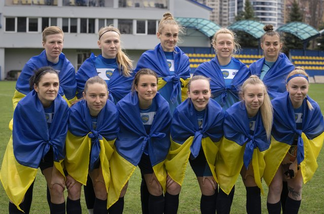 Players of a women's football team from Mariupol pose for photo before a Ukrainian championship match against Shakhtar in Kyiv, Ukraine, Tuesday, April 18, 2023. After their city was devastated and captured by Russian forces, the team from Mariupol rose from the ashes when they gathered a new team in Kyiv. They continue to play to remind everyone that despite the occupation that will soon hit one year, Mariupol remains a Ukrainian city. (Photo by Efrem Lukatsky/AP Photo)