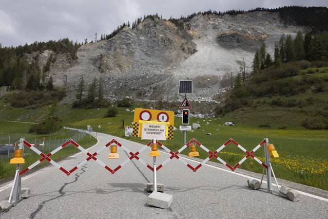 A road is blocked in front of the “Brienzer Rutsch” rockfall danger zone in Brienz-Brinzauls, Switzerland, Friday, May 12, 2023. Authorities in eastern Switzerland have ordered residents of the tiny village of Brienz to evacuate by Friday evening because geology experts say a mass of 2 million cubic meters of Alpine rock looming overhead could break loose and spill down in coming weeks. (Photo by Arnd Wiegmann/AP Photo)