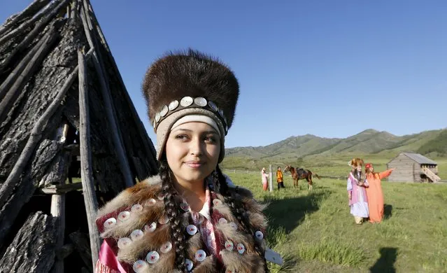 Models dressed in Khakas national costumes perform during the reconstruction of daily life and traditional holidays celebrated by indigenous population of the Republic of Khakassia during a demonstration for visitors at a museum preserve outside Kazanovka village, southwest of the city of Abakan, Russia, July 24, 2015. (Photo by Ilya Naymushin/Reuters)