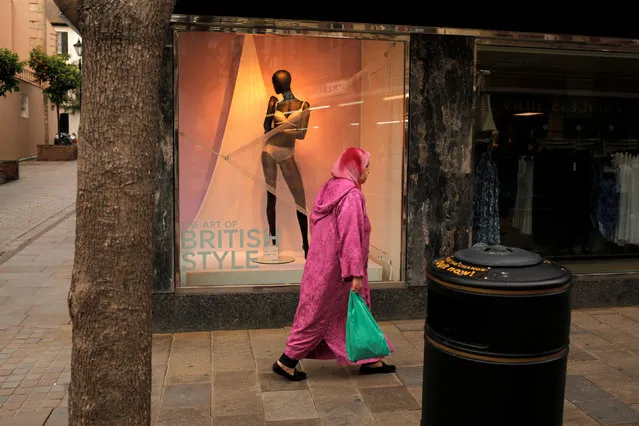 A woman walks past a clothes shop at Main street, in downtown of the British Colony of Gibraltar, April 21, 2016. (Photo by Jon Nazca/Reuters)