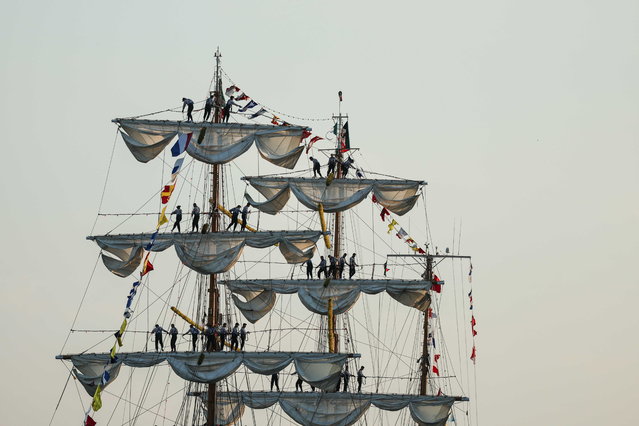 Sailors perform on the three-masted sailboat “Cuauhtemoc” flying the Mexican flag, in the Seine river during Armada 2023, in Rouen, France, 08 June 2023. Armada 2023 is the 8th edition of an event which gathers the most beautiful vessels in the world in the quays of Rouen. (Photo by Mohammed Badra/EPA)