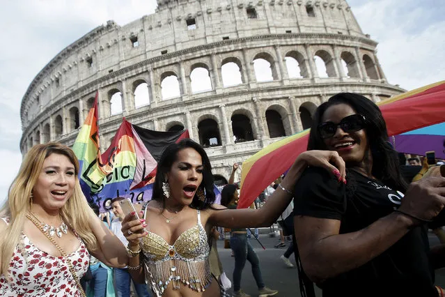 People march past the Colosseum during the Gay Pride parade in Rome, Saturday, June 11, 2016. Italy joined the rest of Europe last month in giving some legal rights to gay couples after a years-long battle and opposition from the Catholic Church to anything that smacked of authorizing gay marriage. (Photo by Fabio Frustaci/AP Photo)