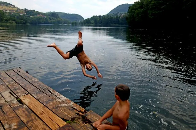 Boys jump into a lake in the central Bosnian town of Jajce, Bosnia and Herzegovina, August 5, 2015. (Photo by Dado Ruvic/Reuters)