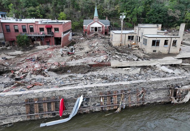 In an aerial view, flood damage, including mangled railroad tracks, wrought by Hurricane Helene is seen along the French Broad River on October 3, 2024 in Marshall, North Carolina. At least 200 people were killed in six states in the wake of the powerful hurricane which made landfall as a Category 4. President Joe Biden took an aerial tour of the devastated region yesterday and ordered the deployment of 1,000 active duty U.S. soldiers to assist with storm relief efforts and reinforce the North Carolina National Guard. (Photo by Mario Tama/Getty Images/AFP Photo)