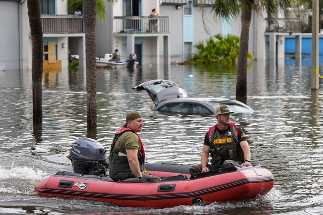 A water rescue boat moves in floodwaters at an apartment complex in the aftermath of hurricane Milton, Thursday, October 10, 2024, in Clearwater, Fla. (Photo by Mike Stewart/AP Photo)