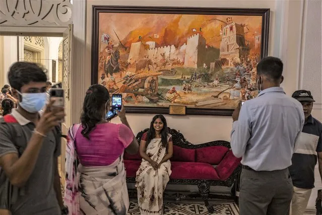 People take pictures at President Gotabaya Rajapaksa's official residence on the second day after it was stormed in Colombo, Sri Lanka, Monday, July 11, 2022. (Photo by Eranga Jayawardena/AP Photo)
