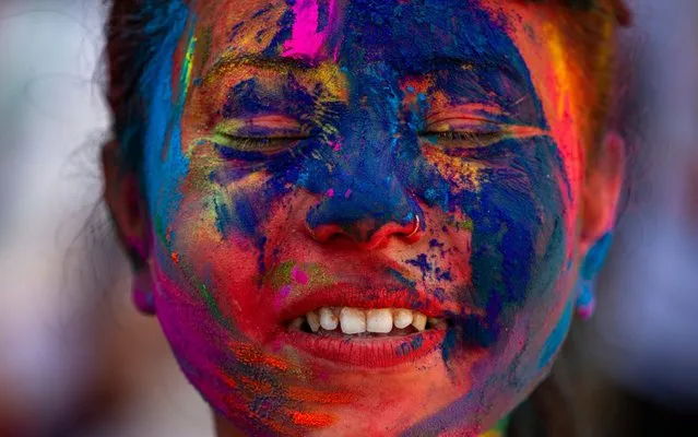 A local is covered in colored powder during Holi Festival celebrations in Kathmandu, Nepal, 09 March 2020. Holi, also known as the Festival of Colors, marks the beginning of spring and is celebrated all over Nepal and neighboring India. (Photo by Narendra Shrestha/EPA/EFE/Rex Features/Shutterstock)