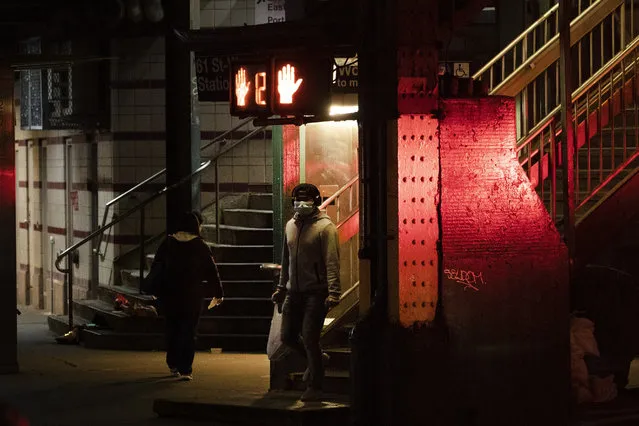 A man walks out of a subway station in the Queens borough of New York, Thursday night, April 23, 2020, during the coronavirus pandemic. More evidence is emerging that far more New Yorkers have had the coronavirus than the number confirmed by lab tests, officials said Thursday, offering insight that could help authorities decide how and how quickly to let people stop isolating from friends and return to work. (Photo by Mark Lennihan/AP Photo)