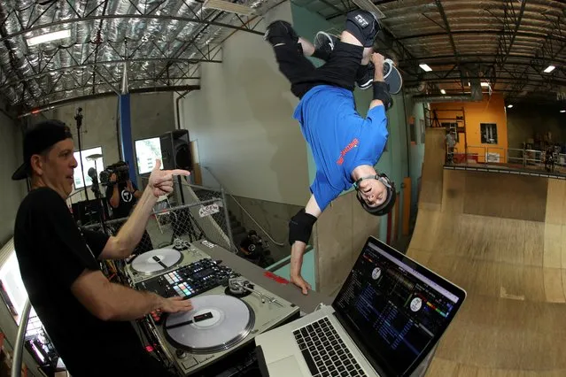 Professional skateboarder Tony Hawk performs an invert off the table of DJ Z-Trip as he rides his office ramp with other professional skateboarders in an internet and social network broadcast to the world in Vista, California, May 8, 2020. (Photo by Mike Blake/Reuters)