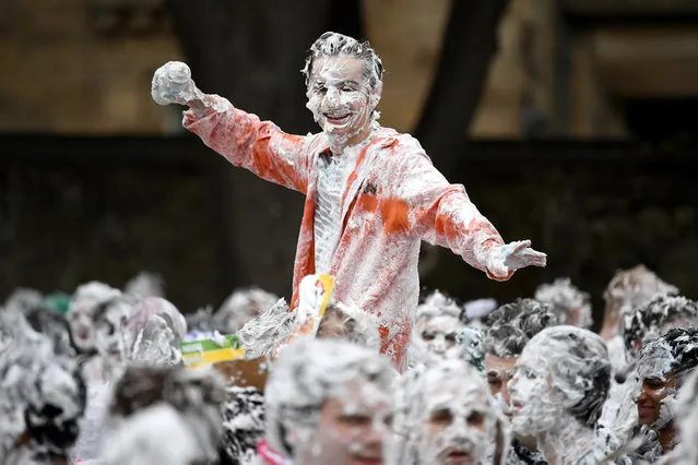 Students from St Andrews University indulge in a tradition of covering themselves with foam to honour the “academic family” on the lower college lawn on October 23, 2017, in St Andrews, Scotland. (Photo by Jeff J. Mitchell/Getty Images)