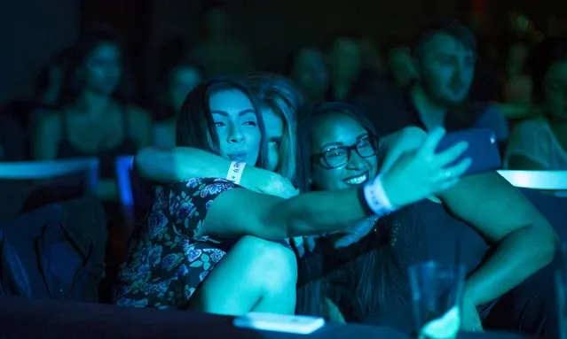 People take a selfie during the “Suicide Girls” Blackheart Burlesque show at El Rey theatre in Los Angeles, California September 12, 2015. (Photo by Mario Anzuoni/Reuters)