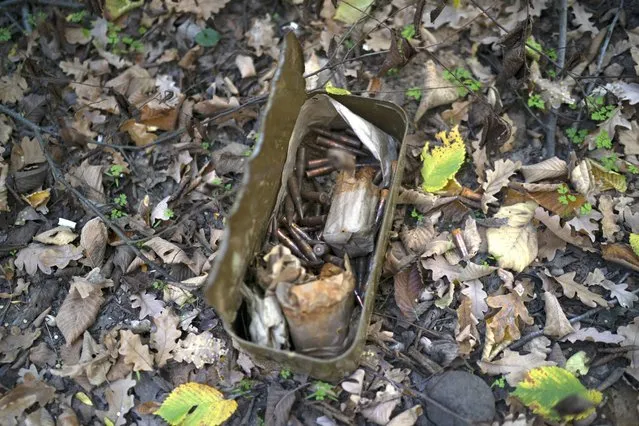 A box with ammunition lies on the ground where trenches were dug by Russian soldiers in a retaken area in Kherson region, Ukraine, Wednesday, October 12, 2022. (Photo by Leo Correa/AP Photo)