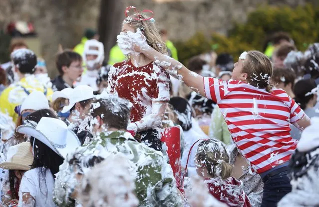 Students from St Andrews University are covered in foam as they take part in the traditional “Raisin Weekend” in the Lower College Lawn, at St Andrews in Scotland, Britain on October 17, 2022. (Photo by Russell Cheyne/Reuters)