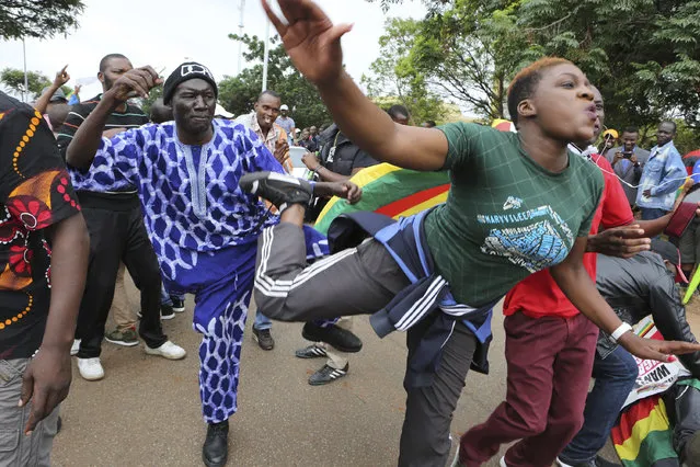 Euphoric crowds march and dance on the streets of Harare, demanding the departure of President Robert Mugabe, Saturday November 18, 2017. The military, which put Mugabe under house arrest this week, has approved the demonstration that includes people from across the political spectrum. (Photo by Tsvangirayi Mukwazhi/AP Photo)