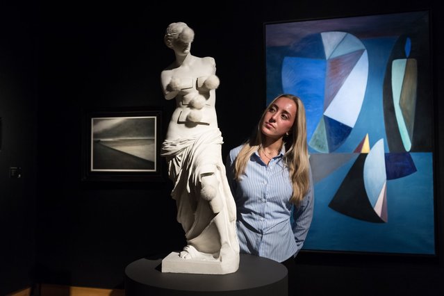A staff member looks at a sculpture by Salvador Dali “Venus de Milo aux tiroirs”, estimate: £400,000 600,000 during a photocall at Christie's auction house ahead of the 20th/21st Century and the Art of the Surreal evening sales in London, United Kingdom on February 27, 2025. (Photo by Wiktor Szymanowicz/Anadolu via Getty Images)