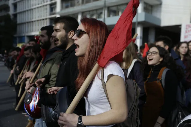 Protesters chants slogans as they march during an demonstration, in central Athens during a 24-hour strike, Thursday, December 14, 2017. Greek workers have walked off their jobs for a 24-hour general strike that is shutting services across the country and suspending ferry services to and from the islands. Unions called Thursday's strike to protest austerity measures that will continue beyond next year's end of Greece's third international bailout package. (Photo by Thanassis Stavrakis/AP Photo)