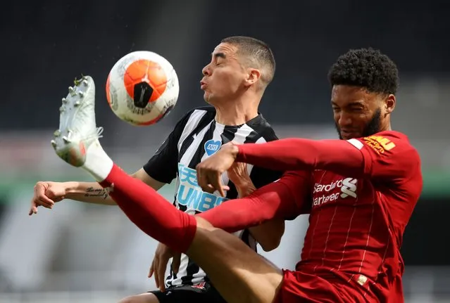 Liverpool's Joe Gomez, right, challenges Newcastle's Miguel Almiron during the English Premier League soccer match between Newcastle and Liverpool at St. James' Park in Newcastle, England, Sunday, July 26, 2020. (Photo by Owen Humphreys/Pool via AP Photo)