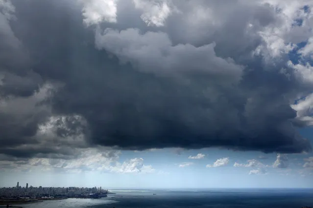 A picture taken on May 24, 2020, shows storm clouds forming over the Lebanese capital Beirut. (Photo by Patrick Baz/AFP Photo)