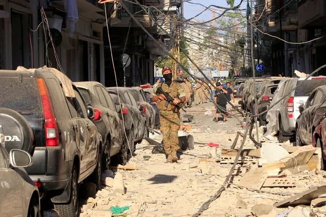 A member of security forces walks past the damage near the site of Tuesday's blast in Beirut's port area, Lebanon on August 5, 2020. (Photo by Aziz Taher/Reuters)