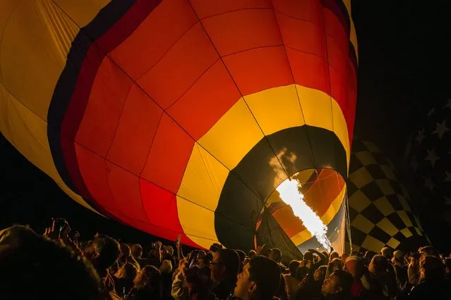 A hot air balloon is lit up by flame as it prepares to take off on the first day of the 2015 Albuquerque International Balloon Fiesta in Albuquerque, New Mexico, October 3, 2015. (Photo by Lucas Jackson/Reuters)