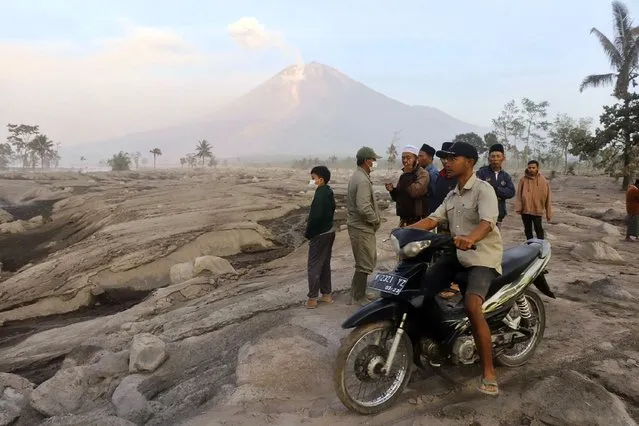 Villagers inspect an area affected by the eruption of Mount Semeru in Kajar Kuning vilage in Lumajang, East Java, Indonesia, Monday, December 5, 2022. (Photo by Imanuel Yoga/AP Photo)