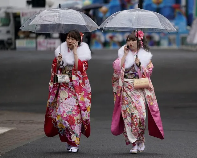 Japanese participants clad in Japanese kimono walk together after a Coming of Age ceremony at Toshimaen amusement park on the national holiday in Tokyo, Monday, January 8, 2018. (Photo by Shizuo Kambayashi/AP Photo)