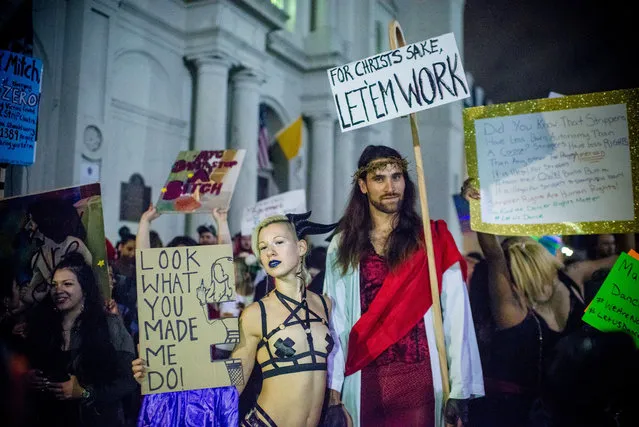 Strip club dancers, workers, and supporters march in in New Orleans on February 1, 2018, to protest the recent police raids that cited and closed several strip clubs on Bourbon Street. (Photo by Emily Kask/AFP Photo)