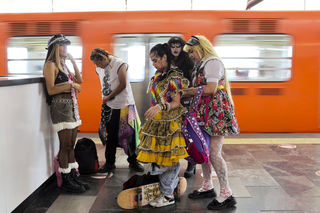 Mexican designer Italia Segovia, 26, known as Kumiko, helps her friend Priscila Rubio, 26, known as Tres, wear a dress from Segovia's brand Chicanjuku, a fusion of Mexican-American Chicano culture and Japanese Harajuku style, at a subway station in Mexico City, Mexico, on April 29, 2025. (Photo by Raquel Cunha/Reuters)