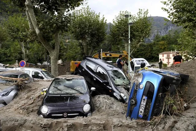 This general view shows a pile of vehicles on a street in Breil-sur-Roya, south-eastern France, on October 4, 2020, after extensive flooding caused widespread damage in the Alpes-Maritimes departement. French and Italian rescue services stepped up their search efforts after floods cut off several villages near the two countries' border, causing widespread damage and killing two people in Italy. Eight people remained unaccounted for on the French side of the border after storms, torrential rain and flash floods battered the area, washing away roads and houses, cutting off entire villages and triggering landslips. (Photo by Nicolas Tucat/AFP Photo)