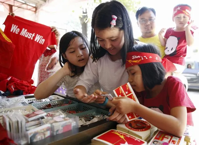 People buy t-shirts and stickers at the National League for Democracy headquarters ahead of Sunday's general election in Yangon, Myanmar, November 5, 2015. Myanmar opposition leader Aung San Suu Kyi said on Thursday she would be "above the president" if her party wins a historic election on Nov. 8, defying a constitutional ban on becoming head of state herself. (Photo by Olivia Harris/Reuters)